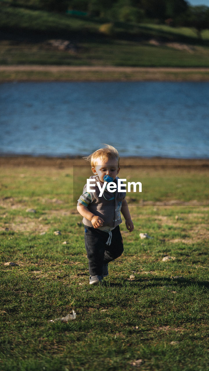 Full length of boy running on land