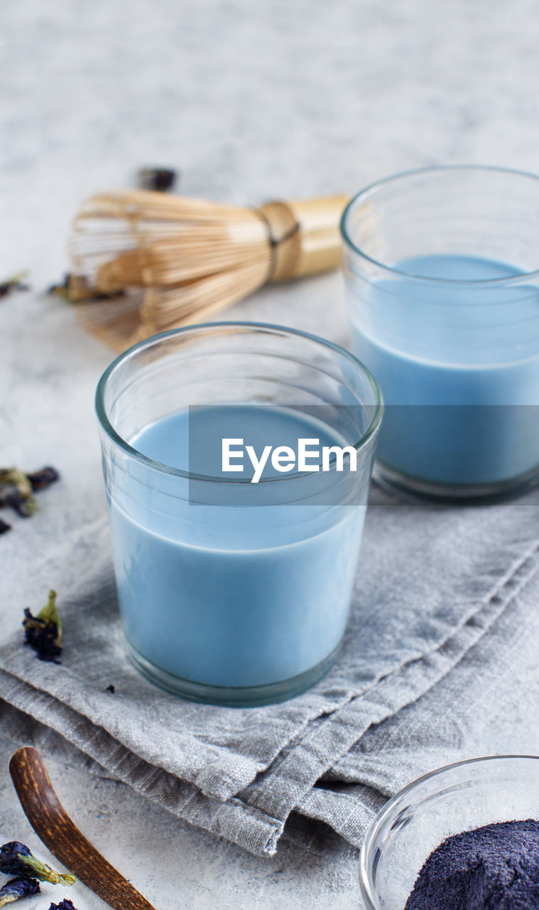 High angle view of blue drink in glasses on table