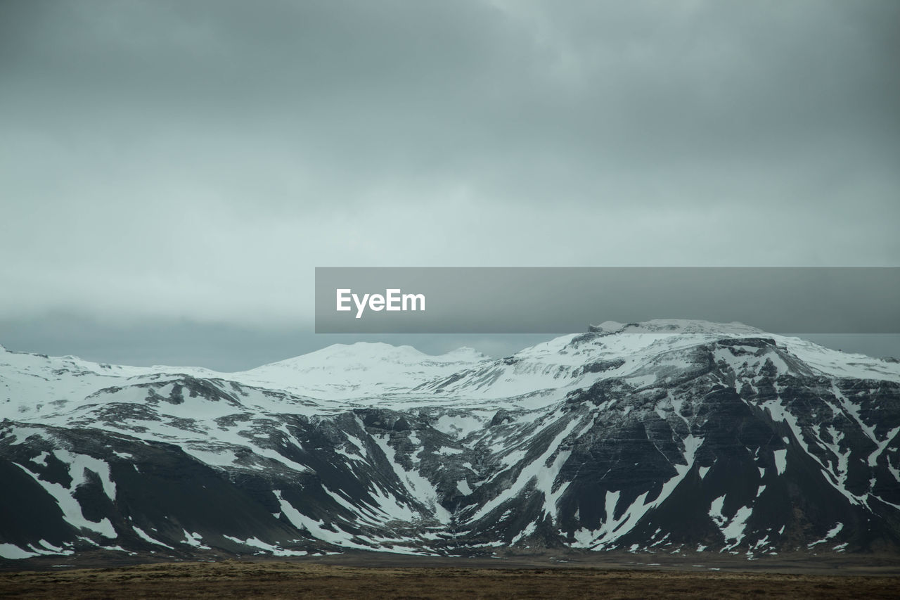 Scenic view of snowcapped mountains against sky