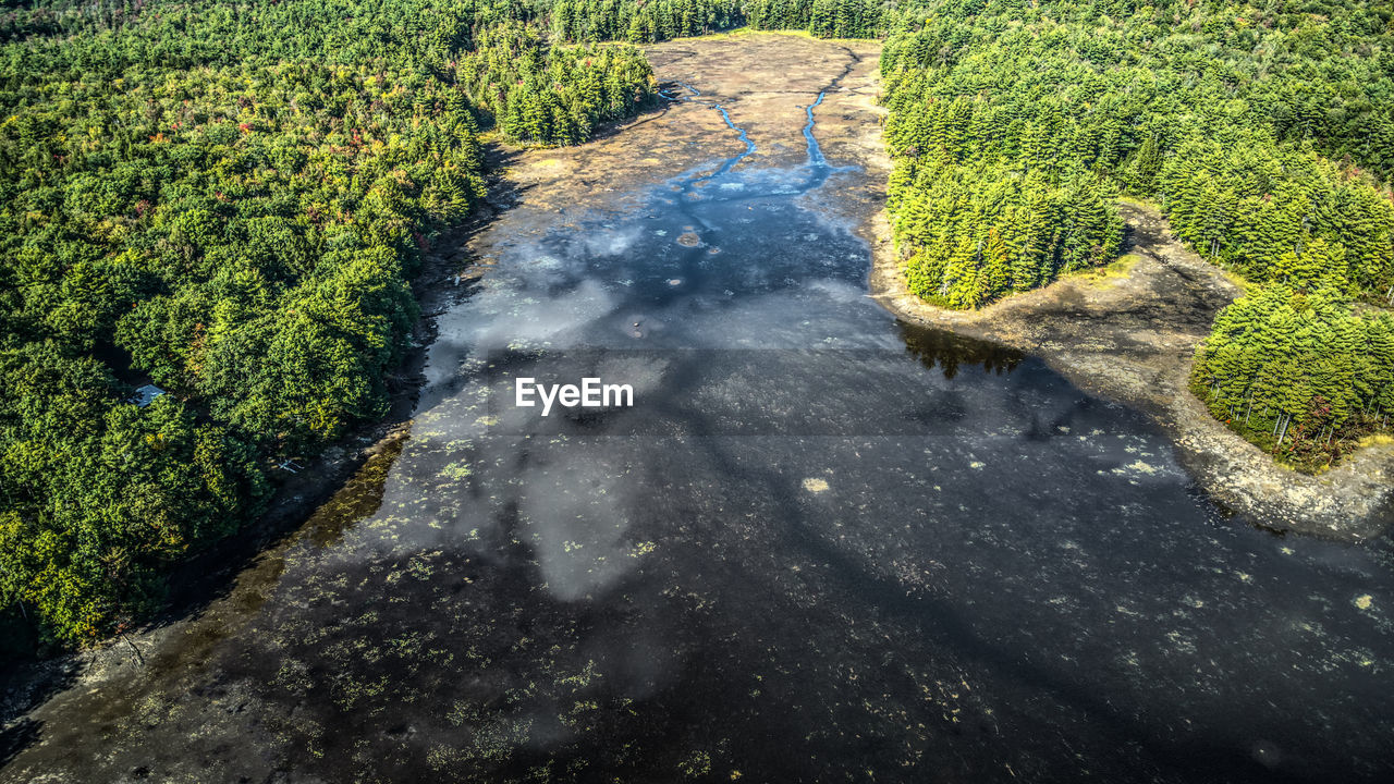 HIGH ANGLE VIEW OF WATER FLOWING ON LAND