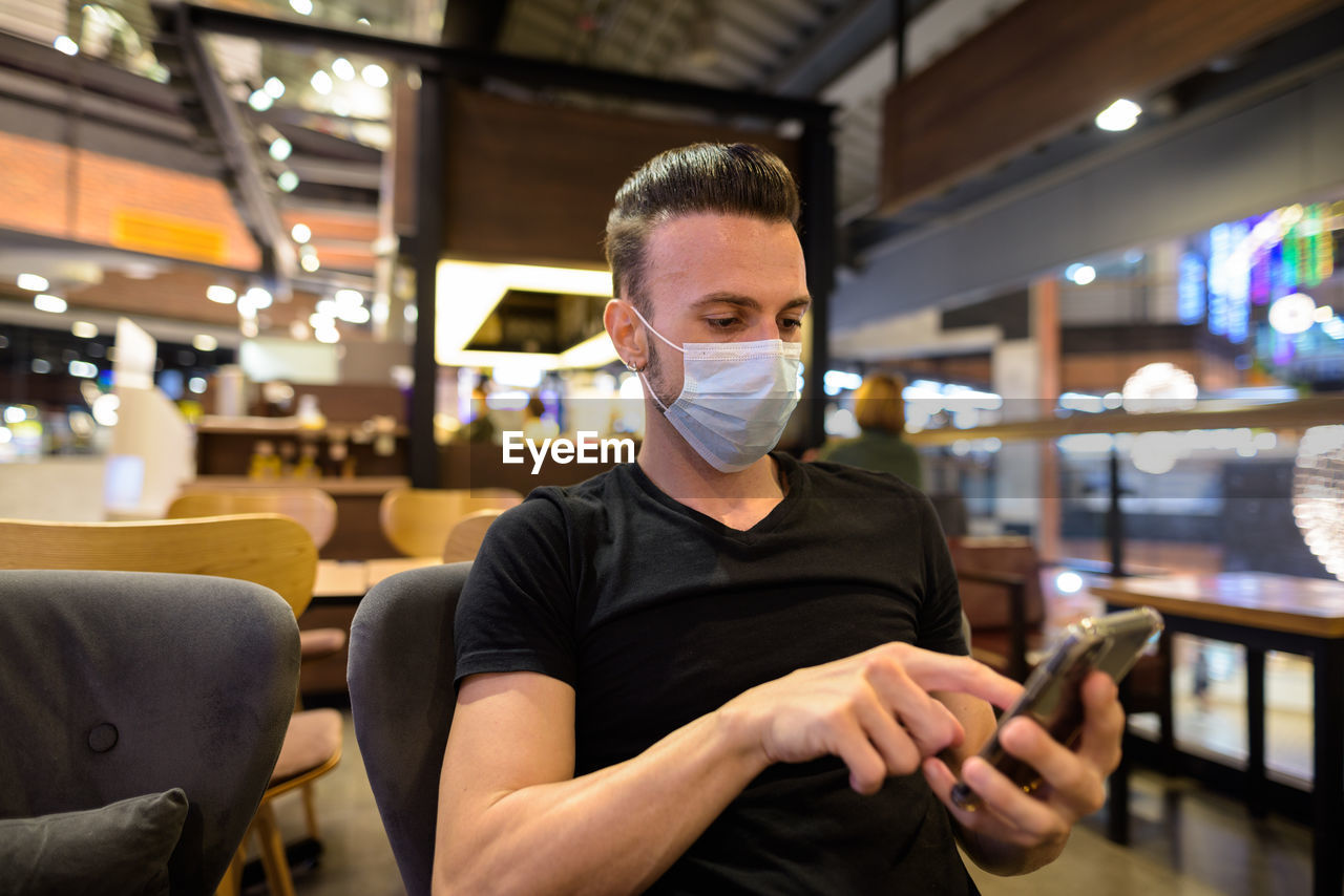 Man using mobile phone at cafe