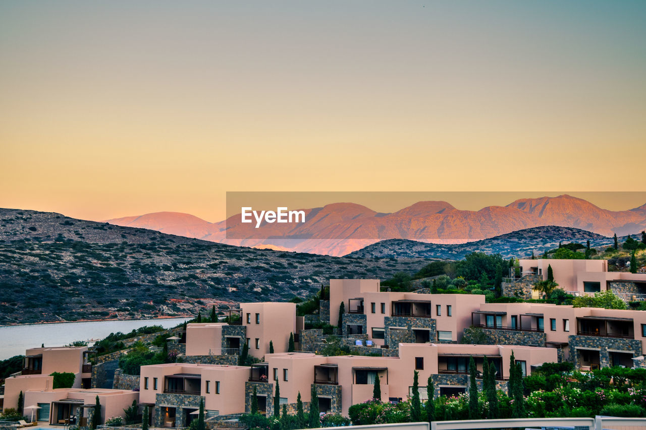 Houses in city during sunset