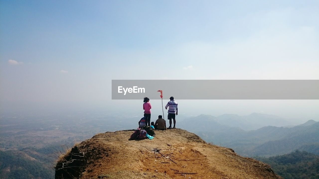 Rear view of friends on cliff