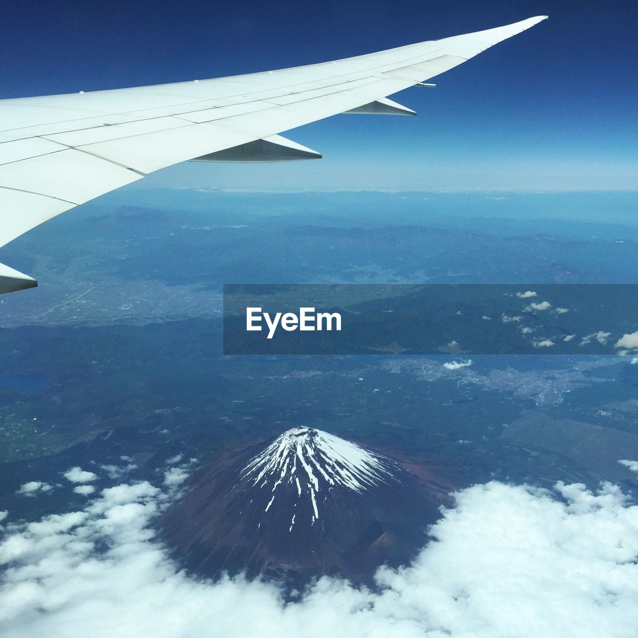 Cropped image of airplane flying over mt fuji against clear sky