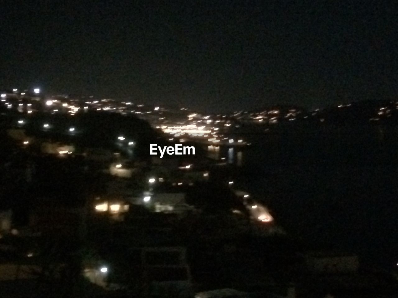 VIEW OF ILLUMINATED CITYSCAPE AT NIGHT