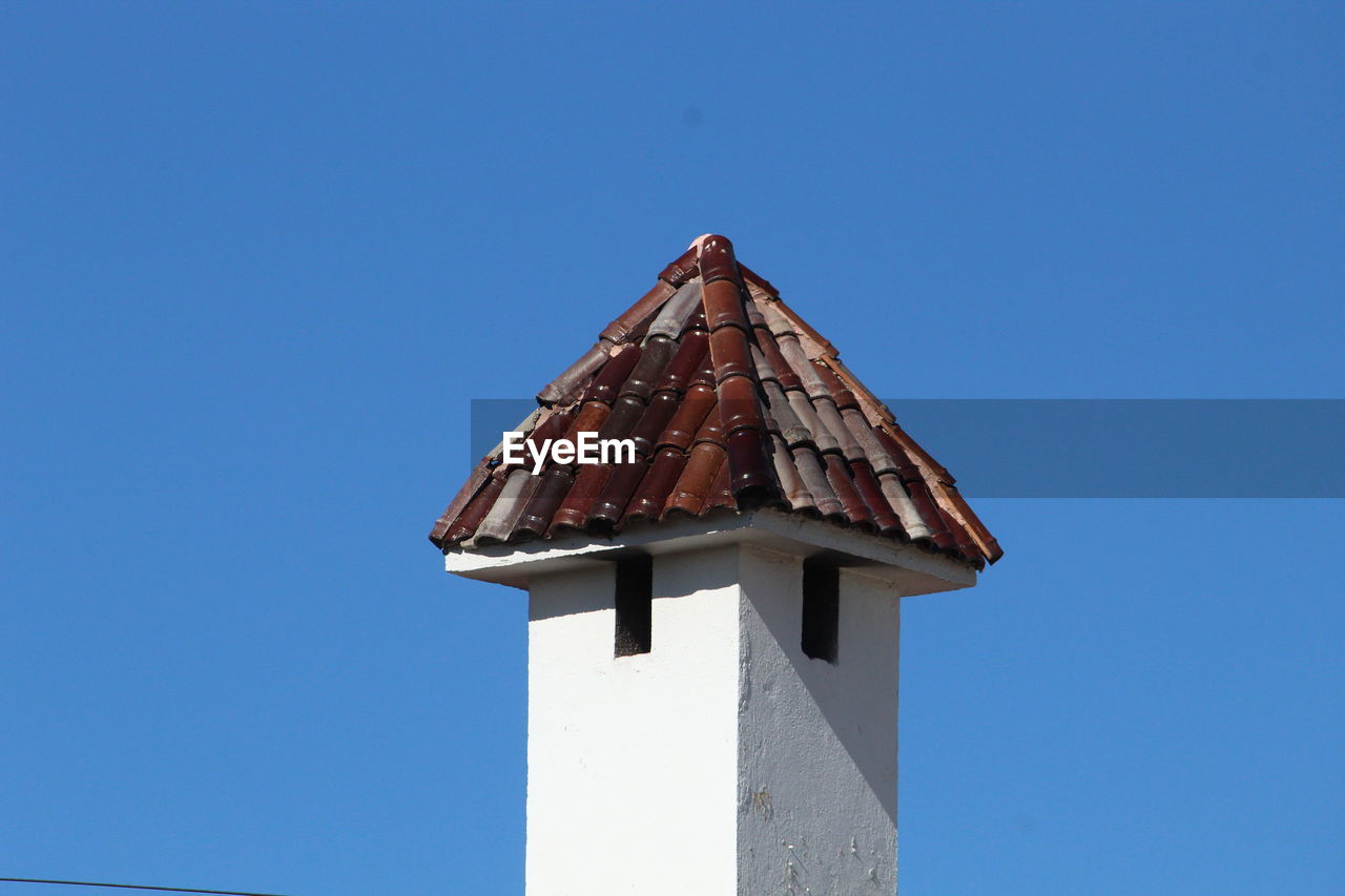 Low angle view of building against clear blue sky