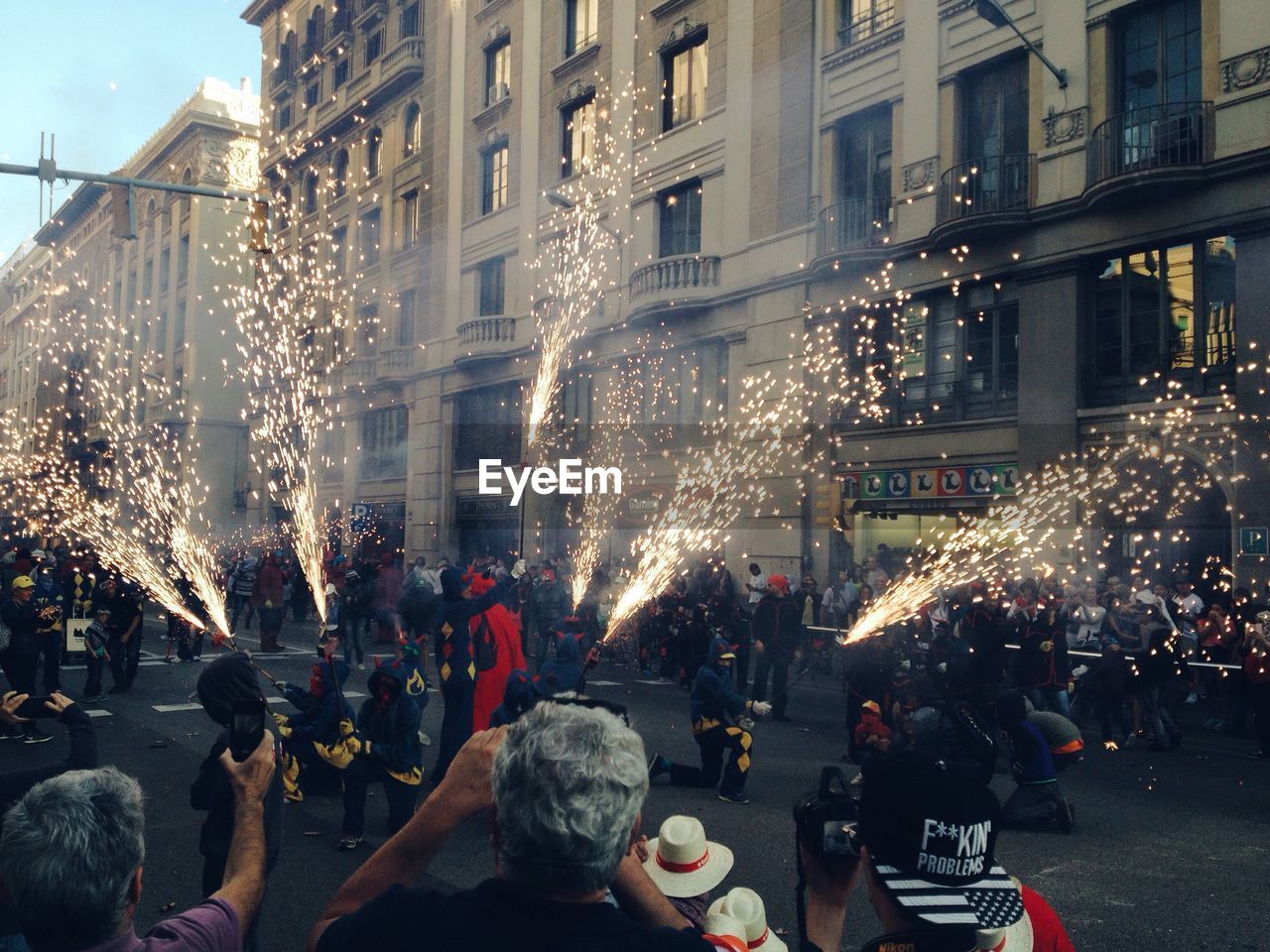 People with firework on city street during la merce