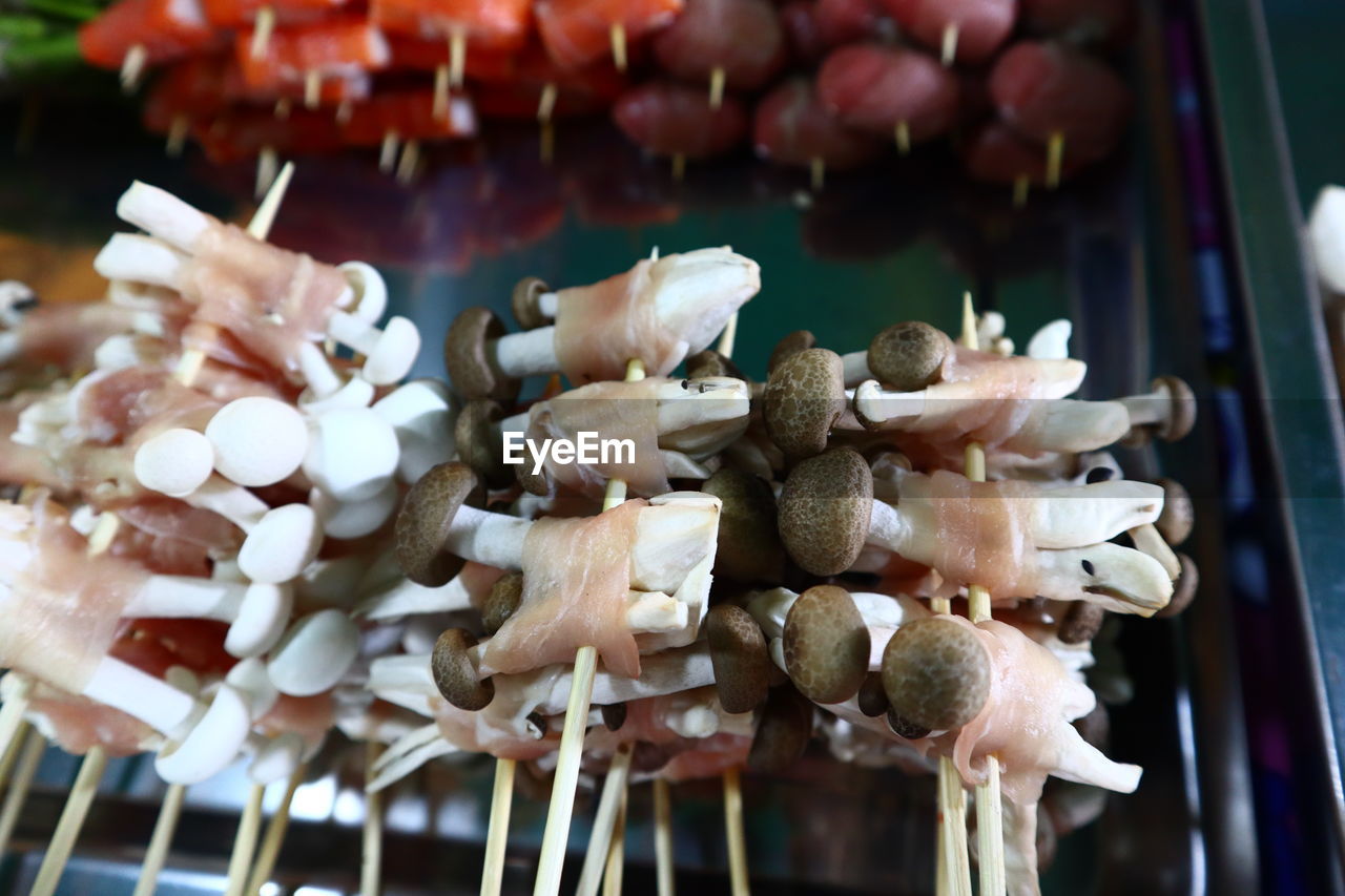 CLOSE-UP OF MUSHROOMS FOR SALE AT MARKET