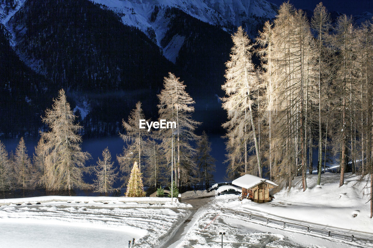 Snow covered landscape against mountain