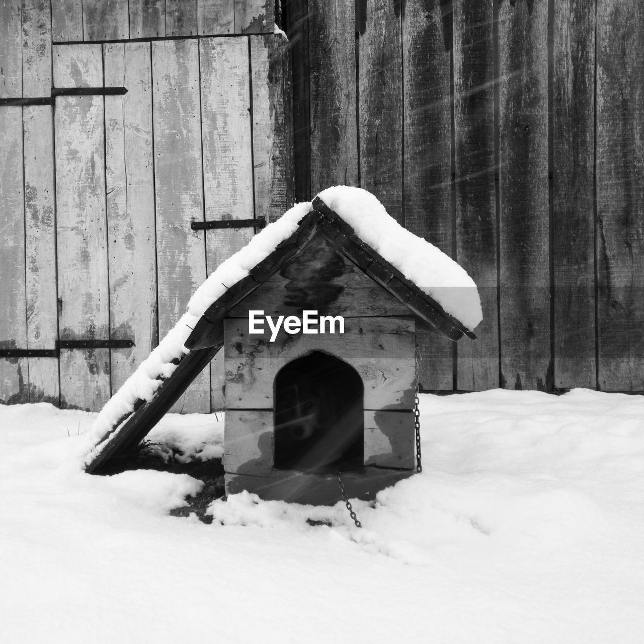 SNOW COVERED FIELD BY BUILDING