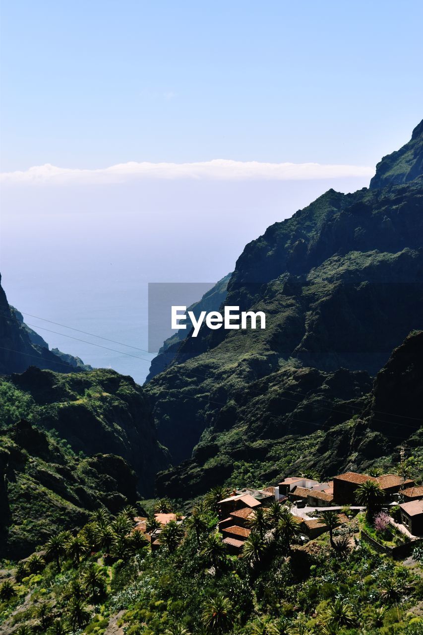 Scenic view of sea and mountains against sky