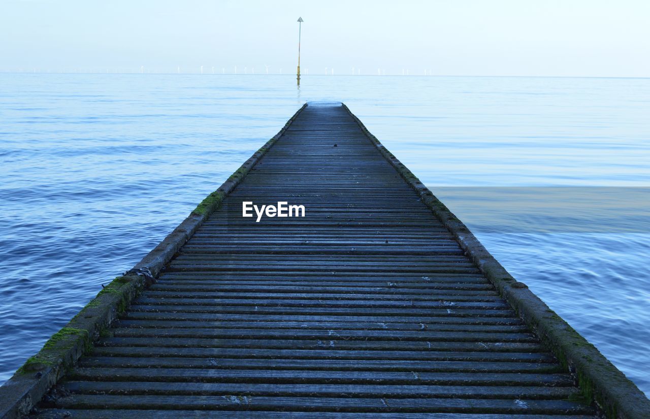 Surface level of wood paneled jetty at calm sea