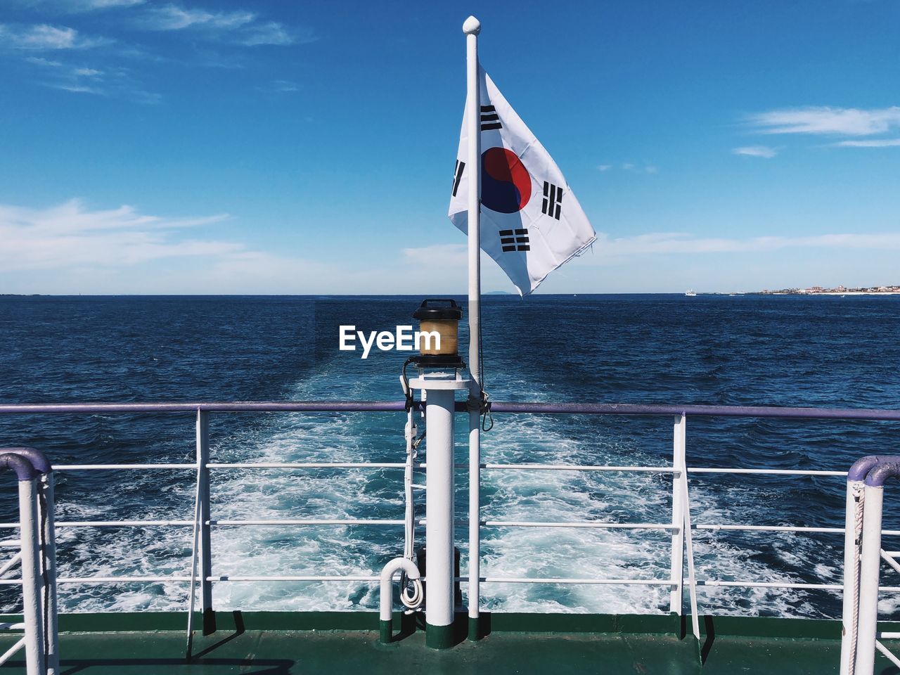 Korean flag flying on boat against blue sky