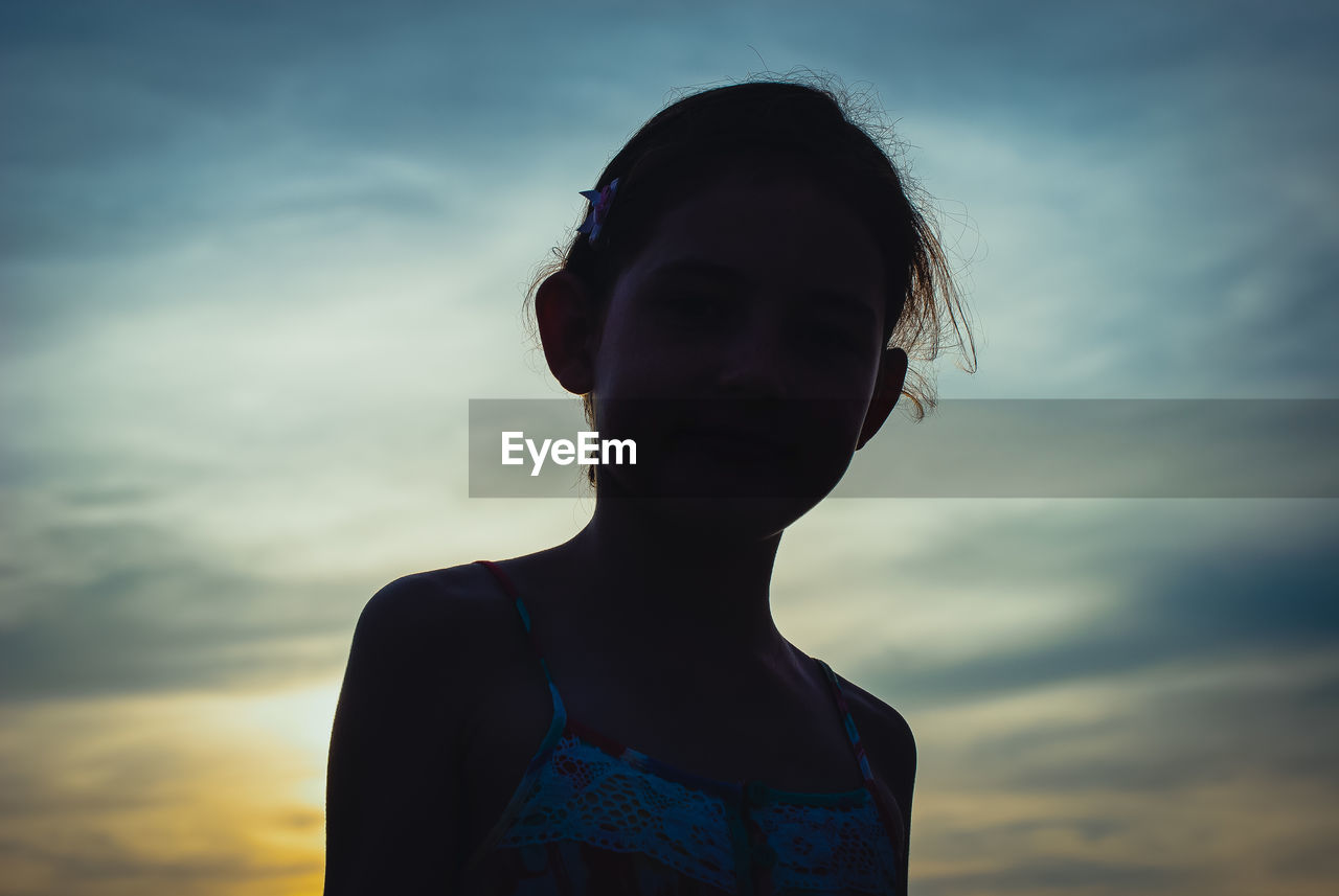 Portrait of girl against sky during sunset