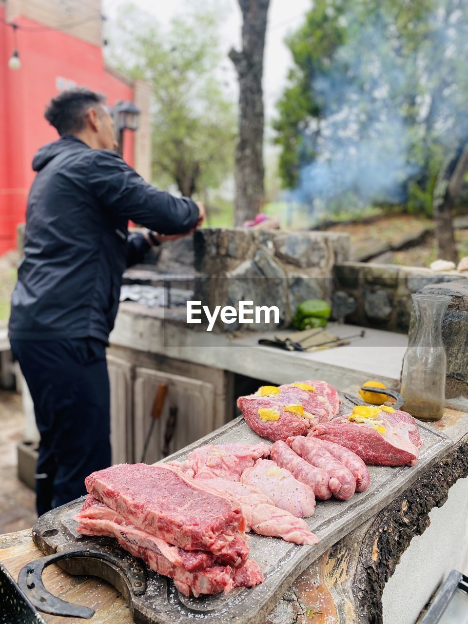 man preparing food on barbecue