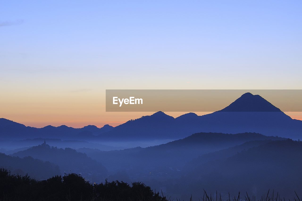 Scenic view of silhouette mountains against clear sky