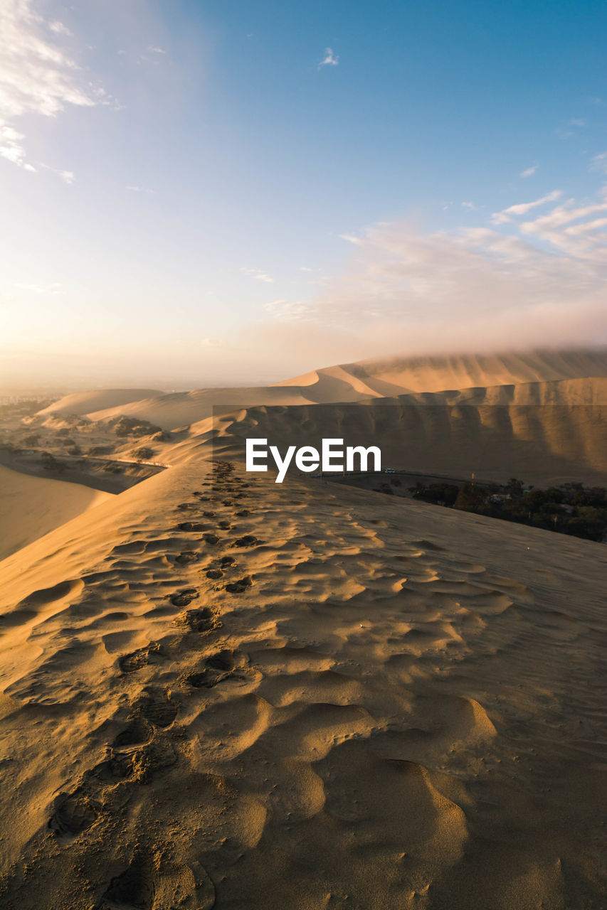 Scenic view of desert against sky during sunset