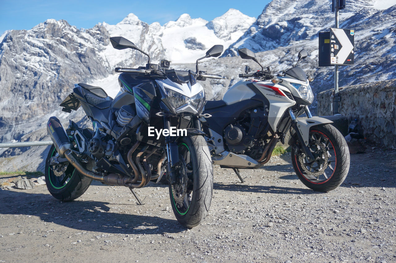 BICYCLES ON ROAD AGAINST MOUNTAINS