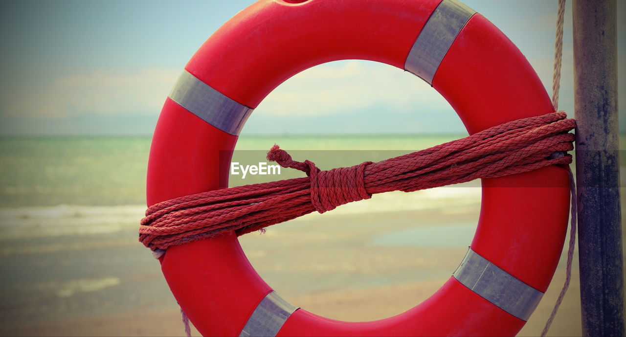 Vintage effect with orange life-buoy on the tropical beach