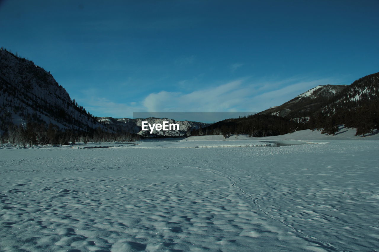 Scenic view of snowcapped mountains against sky