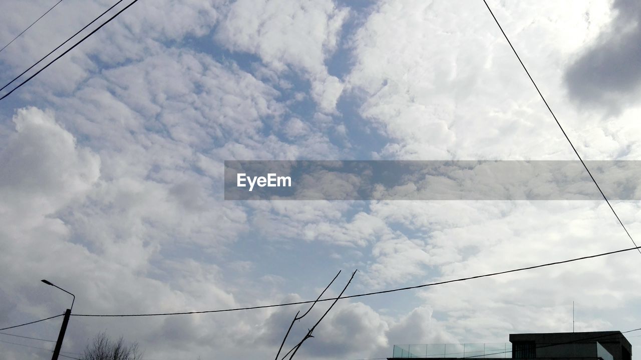 LOW ANGLE VIEW OF ELECTRICITY PYLON AGAINST CLOUDY SKY