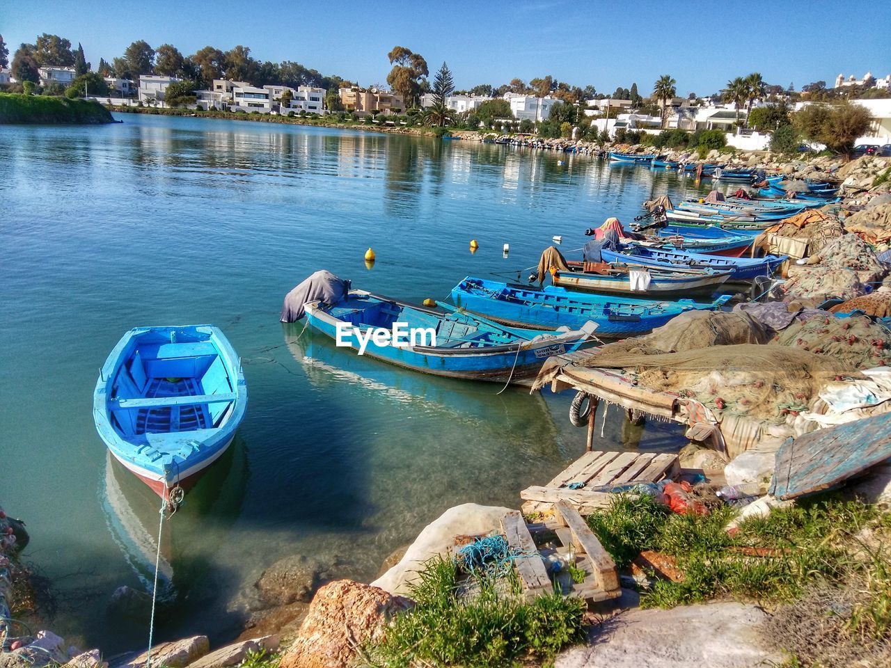 VIEW OF BOATS MOORED IN RIVER