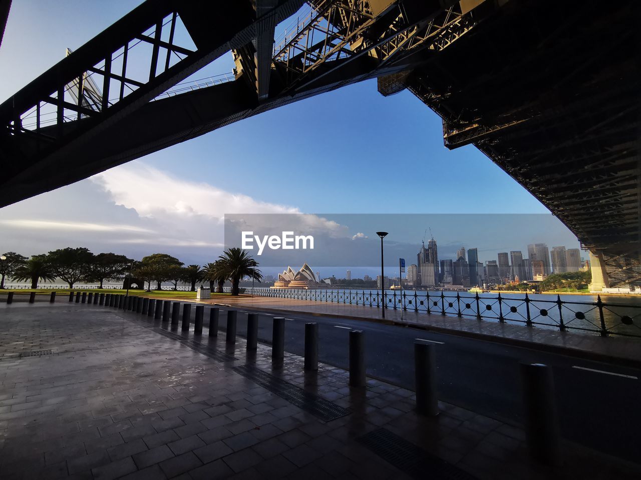 BRIDGE OVER RIVER WITH CITY IN BACKGROUND