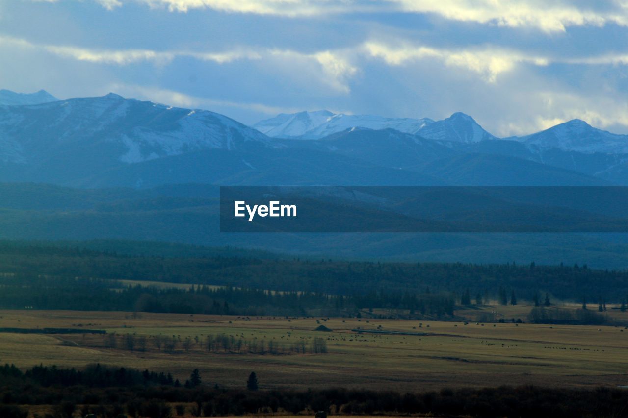 Scenic view of landscape and mountains against sky