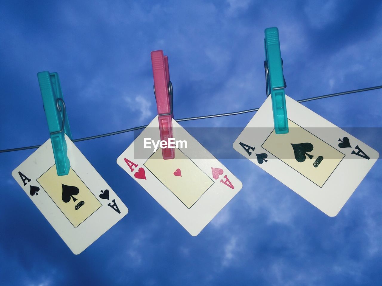 LOW ANGLE VIEW OF FLAGS HANGING AGAINST SKY