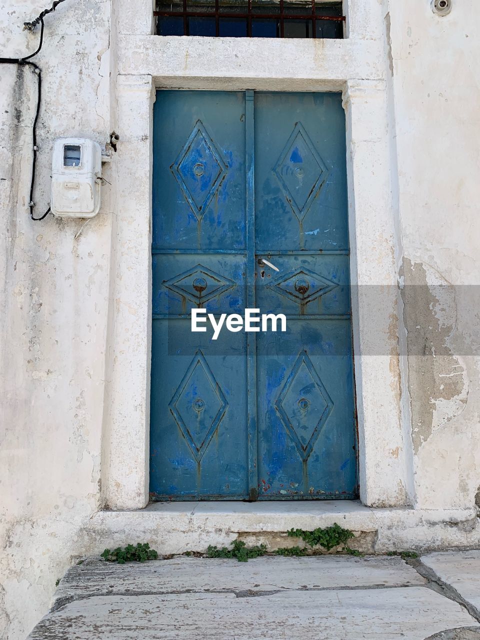 CLOSED BLUE DOOR OF BUILDING