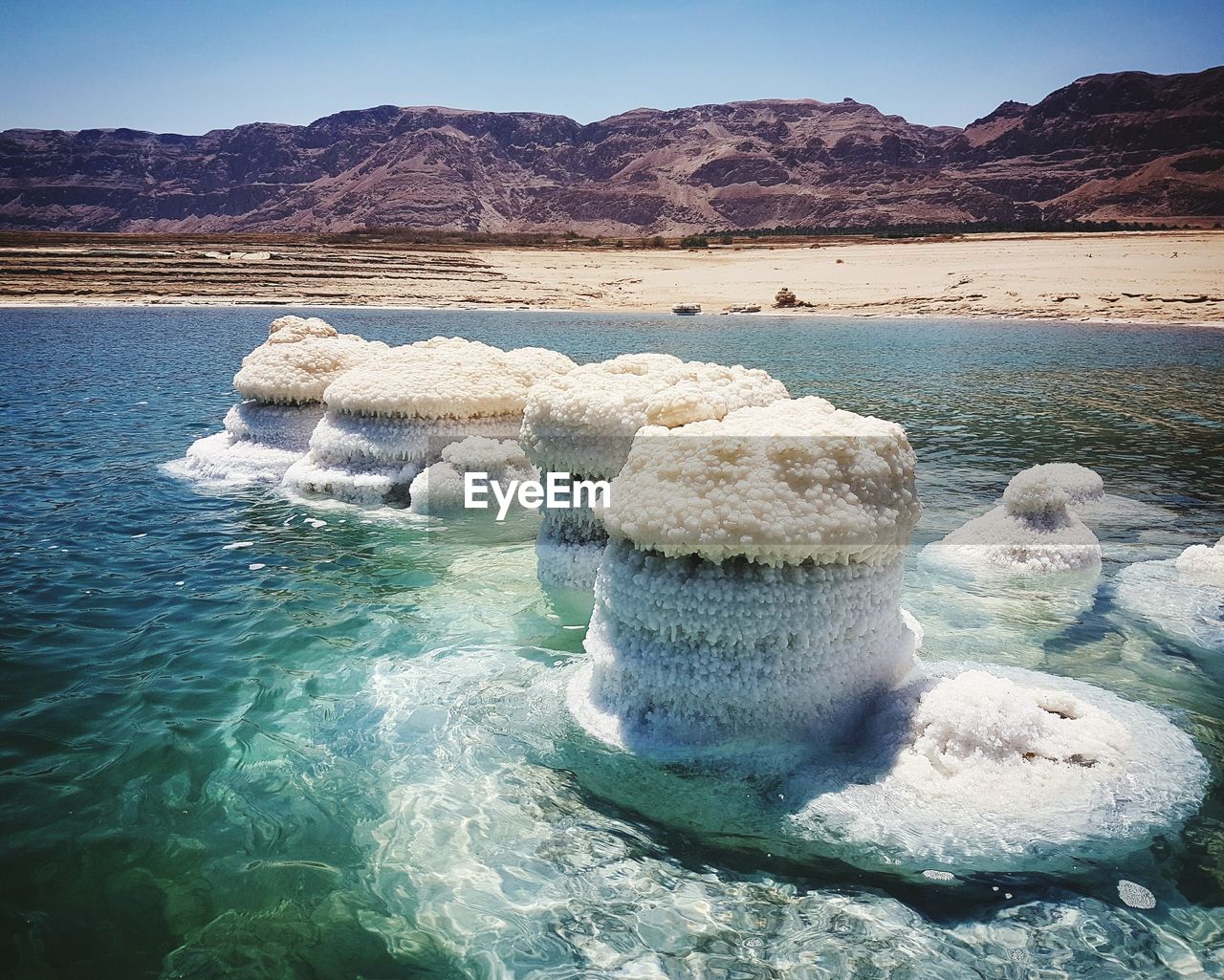 ROCKS IN LAKE AGAINST SKY