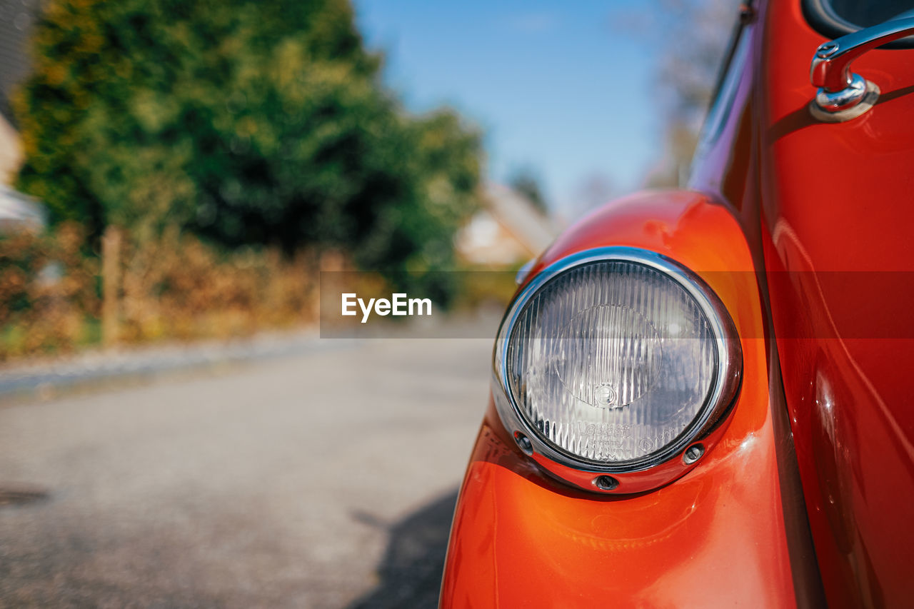 Close up of orange oldtimer on street