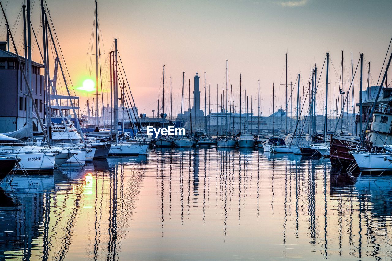 SAILBOATS MOORED AT HARBOR