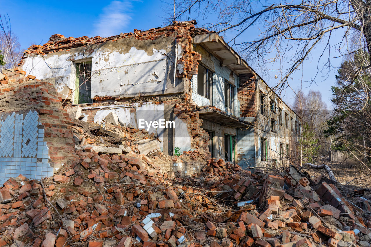 Ruins of an old house in the forest on a sunny spring day