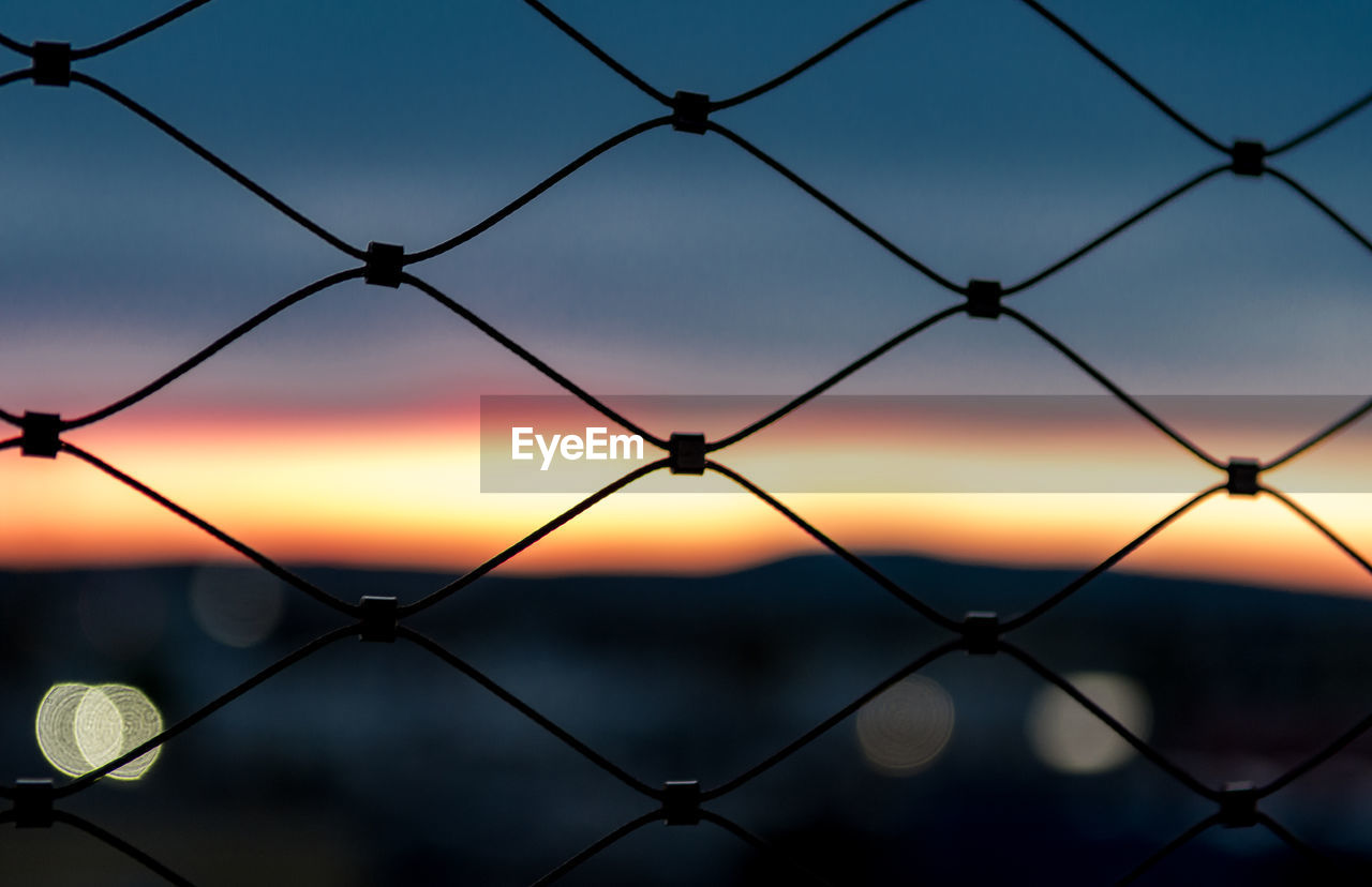 Detail shot of fence against scenic sky