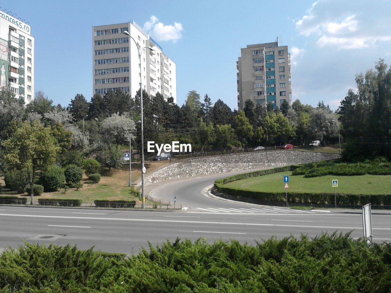 Road in front of buildings against sky