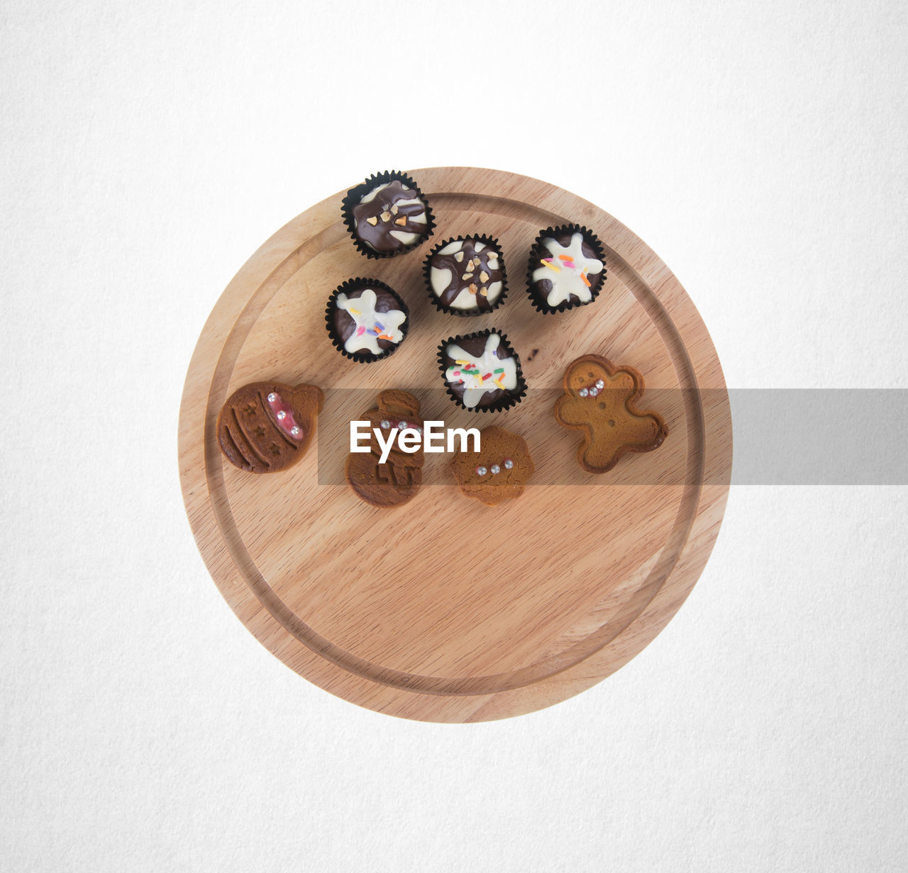 Directly above shot of sweet food on cutting board over white background