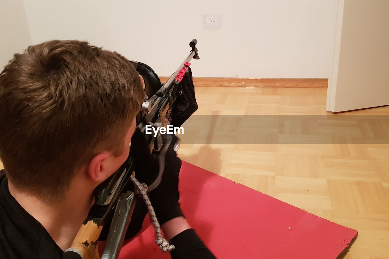 High angle view of boy holding gun