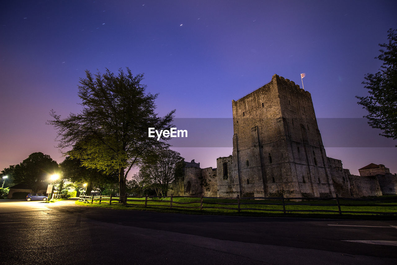 Portchester castle against sky at night