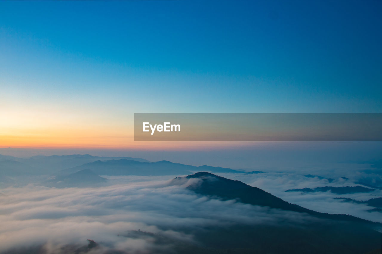 Scenic view of snowcapped mountains against sky during sunset