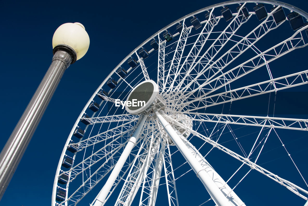 LOW ANGLE VIEW OF FERRIS WHEEL AGAINST CLEAR SKY