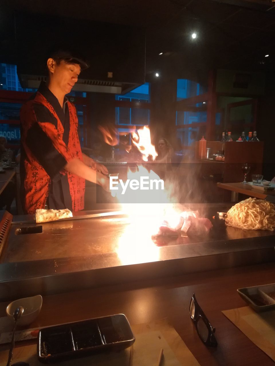 VIEW OF MAN PREPARING FOOD IN KITCHEN