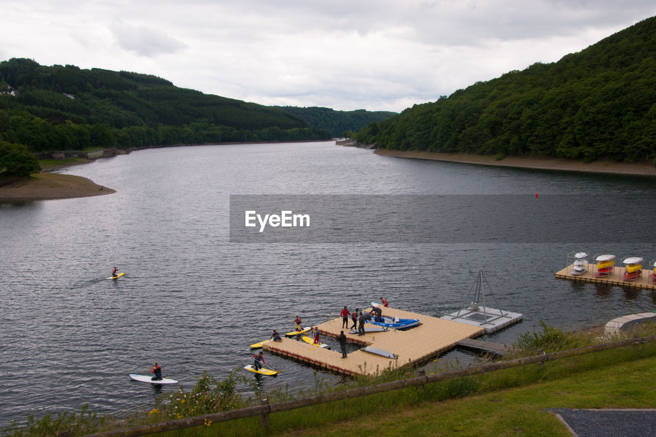 High angle view of men on river against mountains