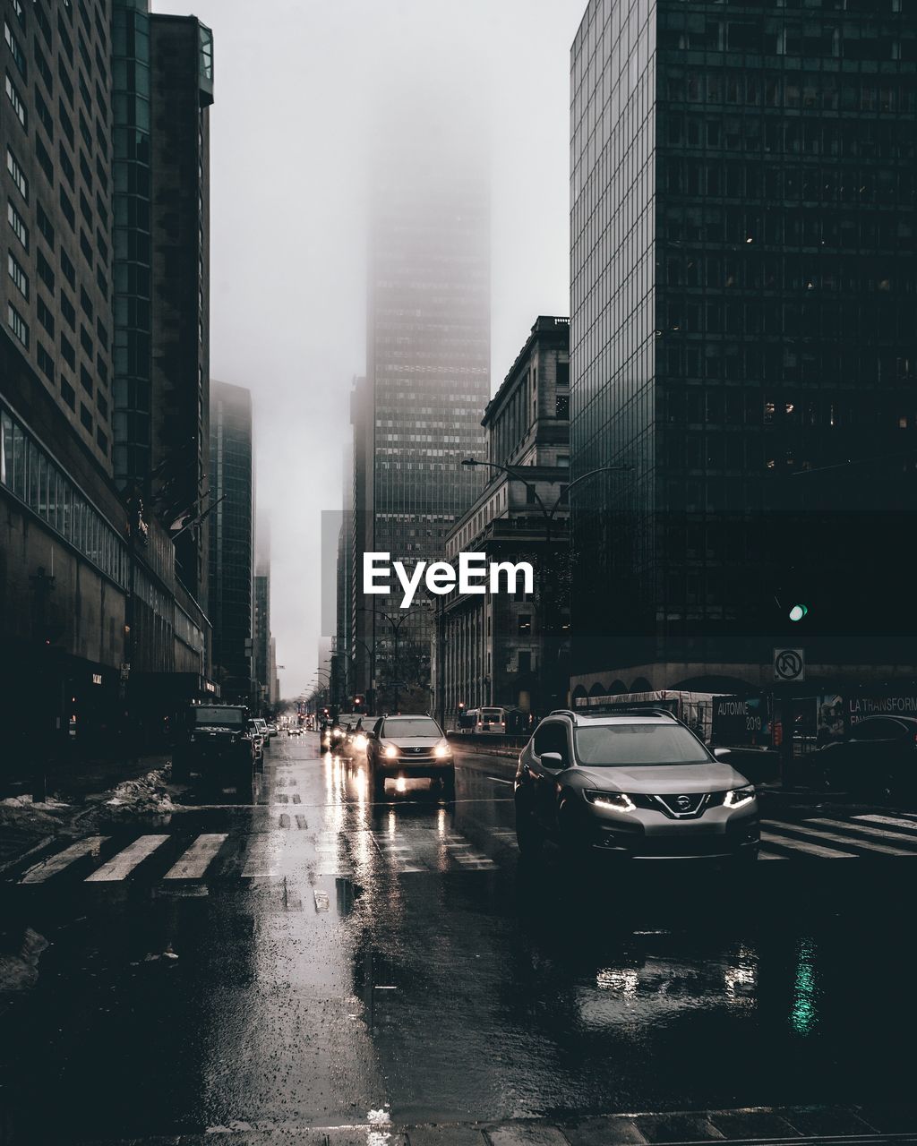 CARS ON CITY STREET DURING RAINY SEASON