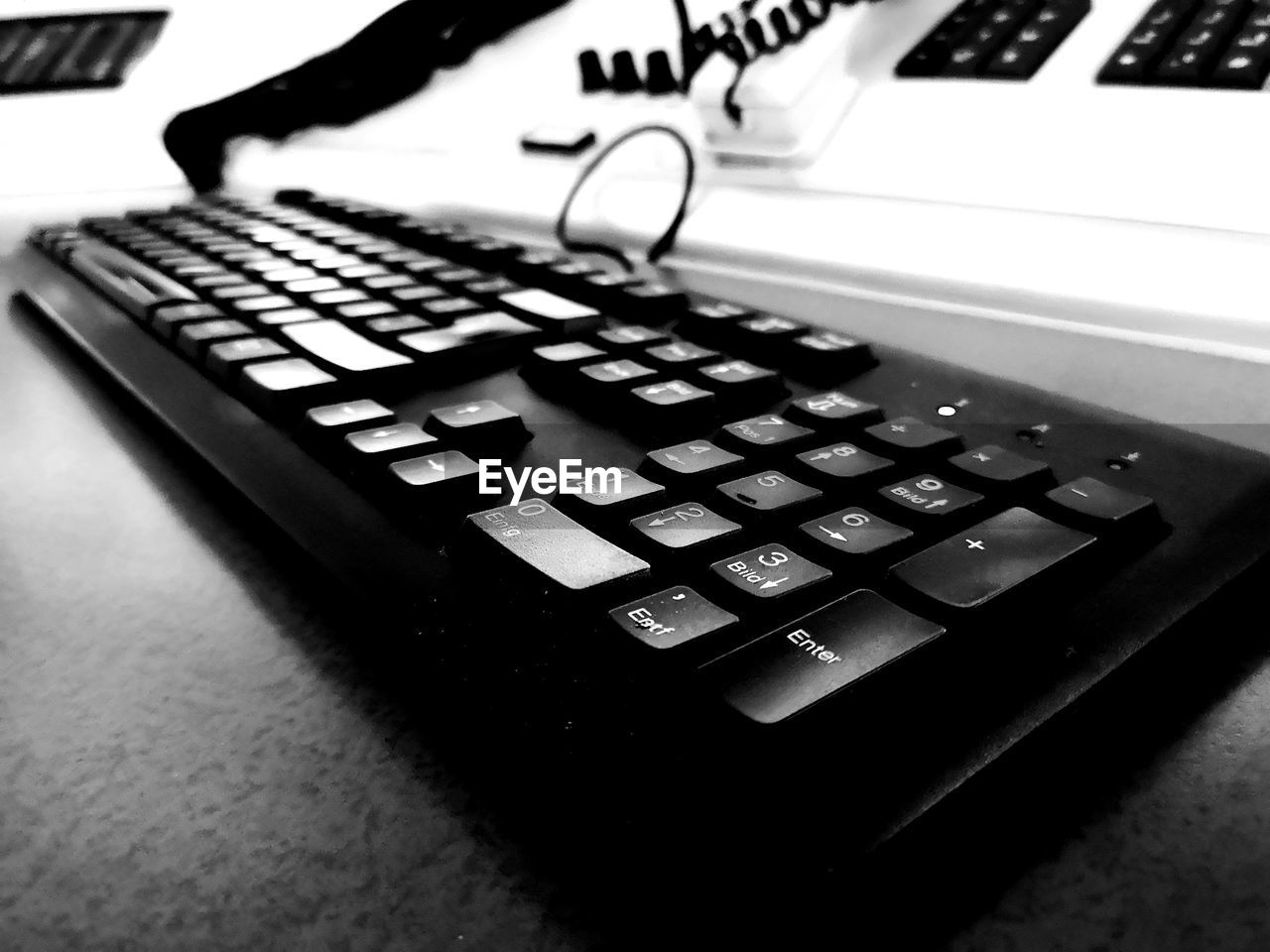 CLOSE-UP OF COMPUTER KEYBOARD ON TABLE AT HOME