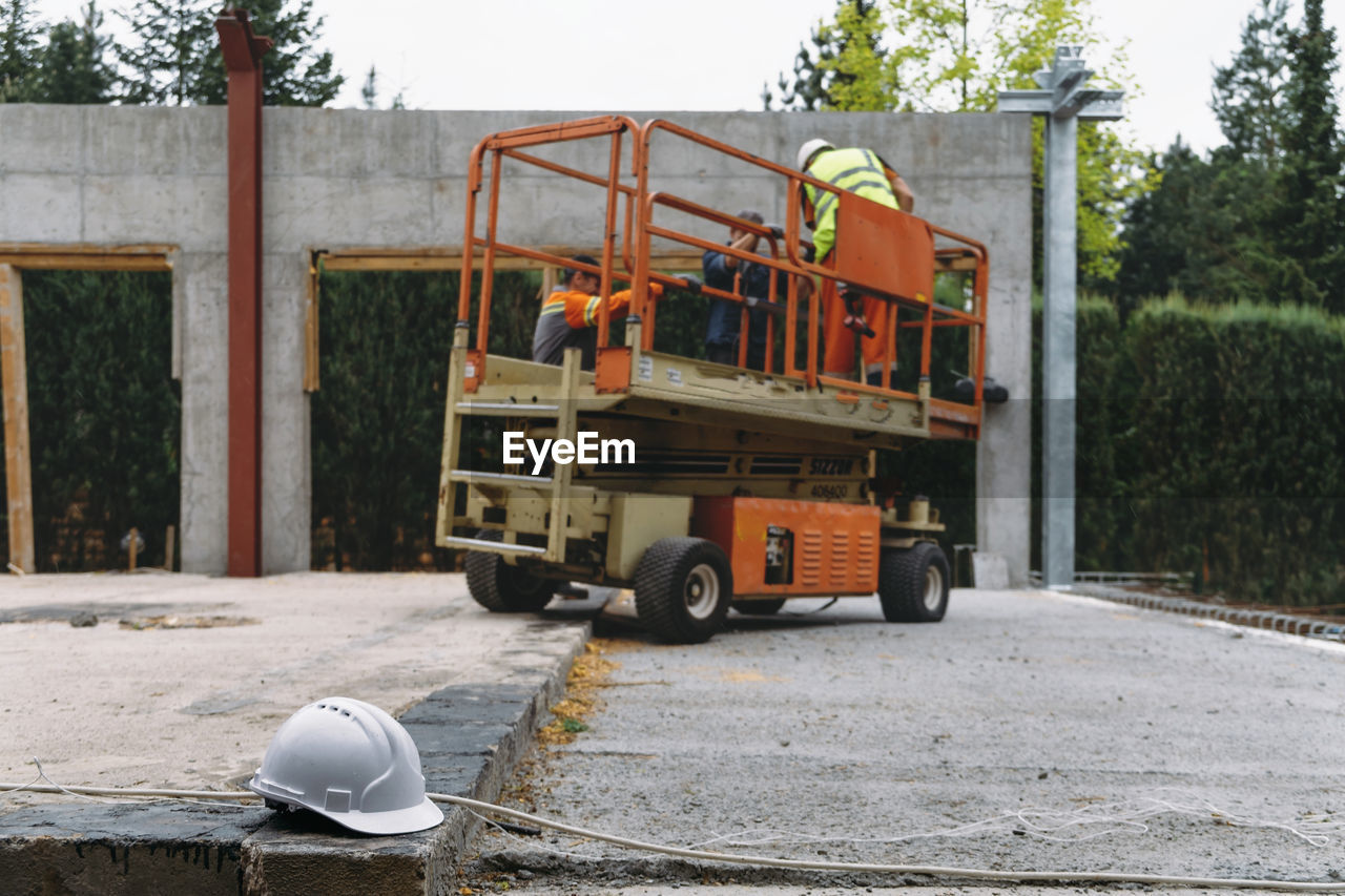 Scissor lift platform on a construction site. building concreate house with mobile transportation