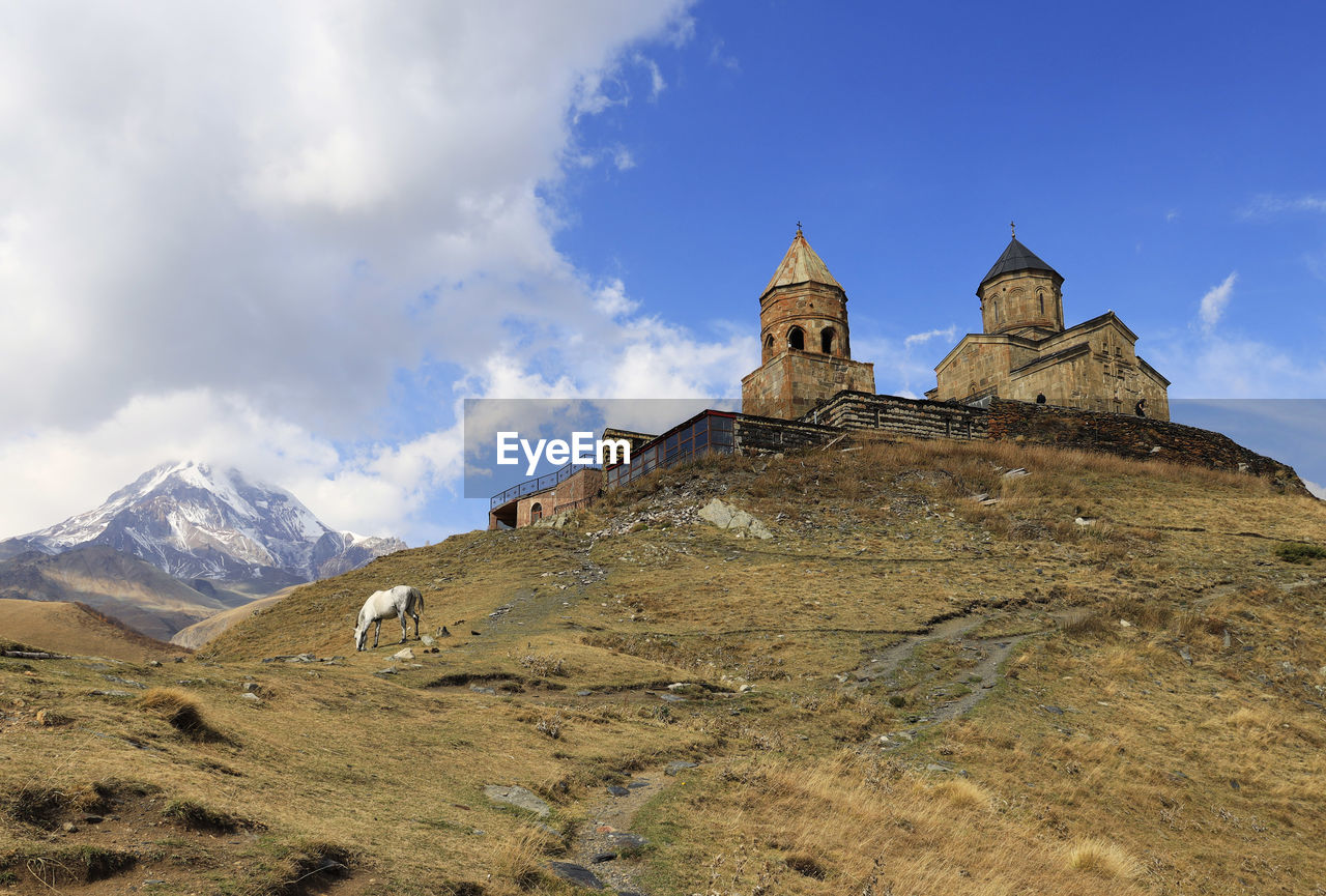 Low angle view of trinity church in gergeti, georgia, asia 