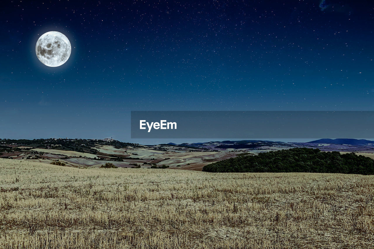 Scenic view of field against sky at night