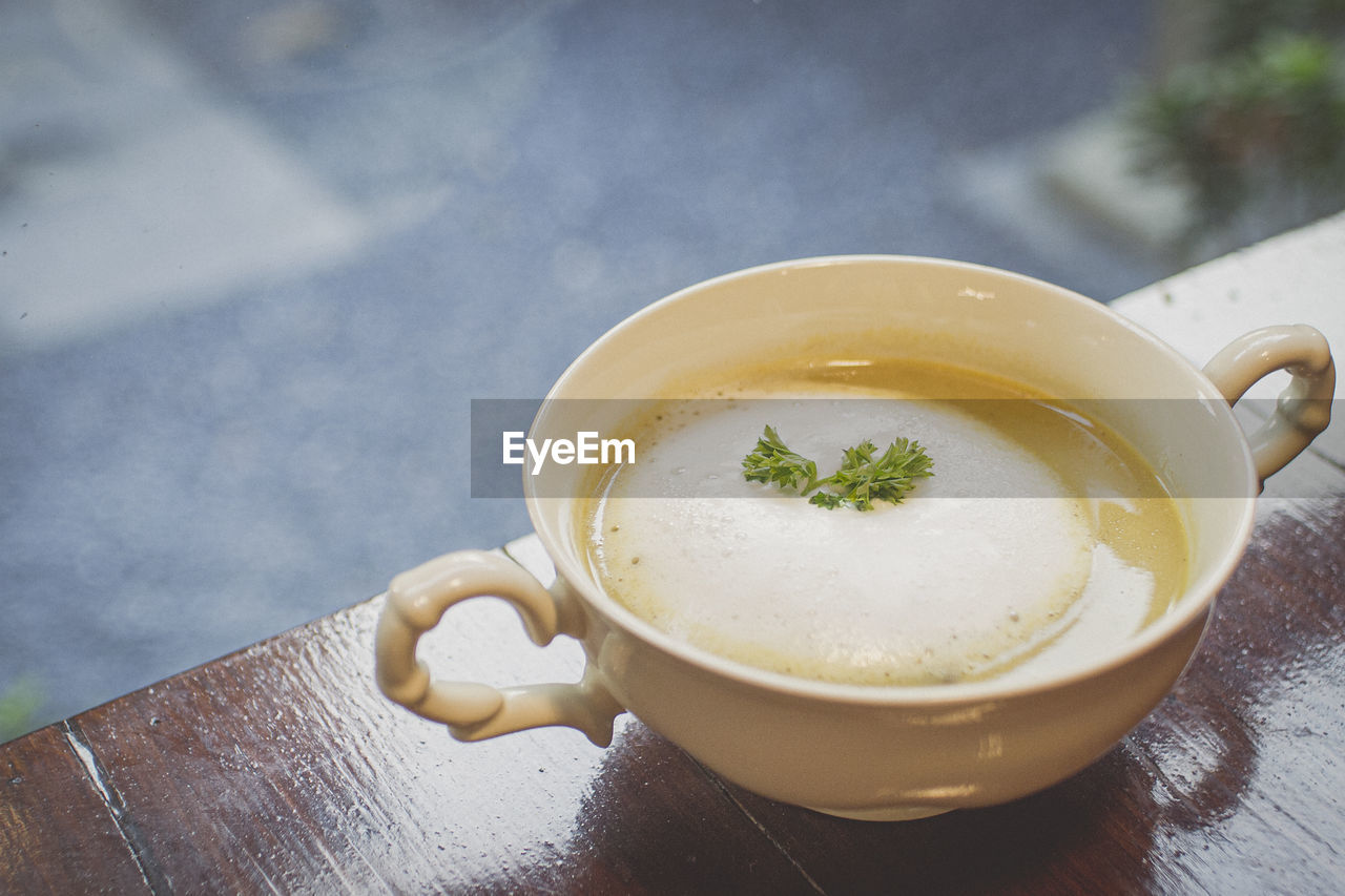 Mushroom soup in ceramic bowl breakfast meal healthy on the wooden table.