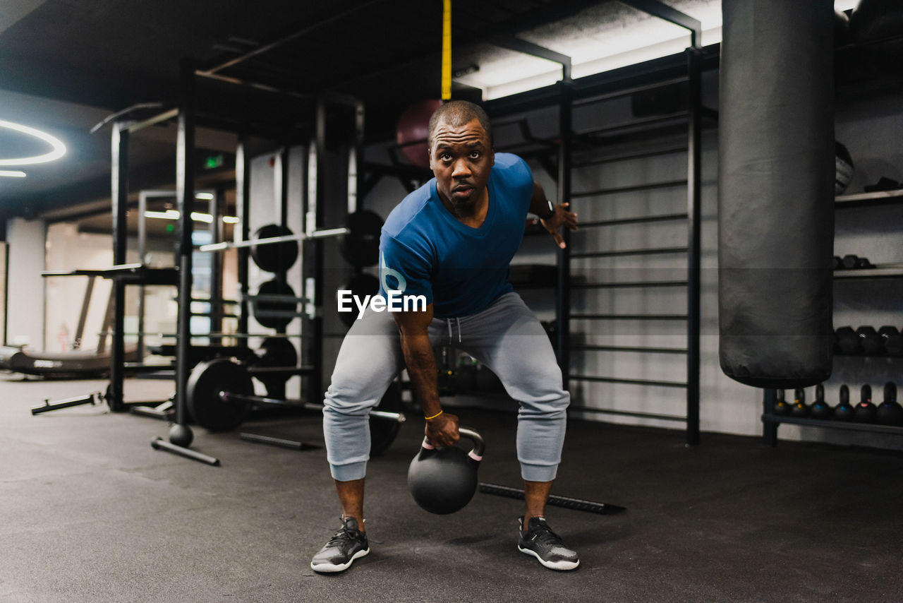 Side view of man exercising in gym